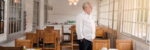 Chef looks out the window of his empty restaurant