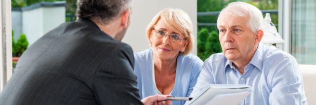 Elderly couple meeting with lawyer