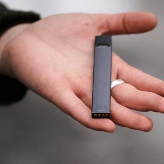 JUUL e-cigarette in palm of hand