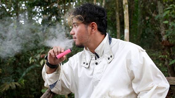 Young man vaping