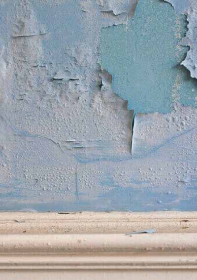Lead paint peeling on an old plaster wall