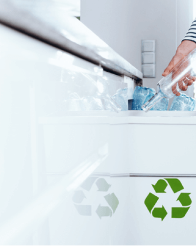Women throwing glass bottle in recycle bin