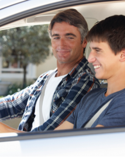 Dad teaching son how to drive