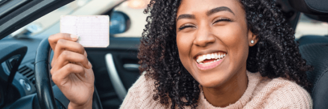 Young girl holding her driver's license