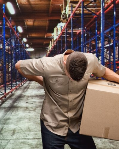 Delivery man having backache due to lifting boxes