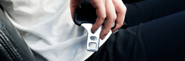 Driver putting on seatbelt