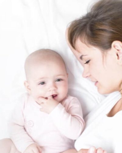 mother laying in bed next to her child