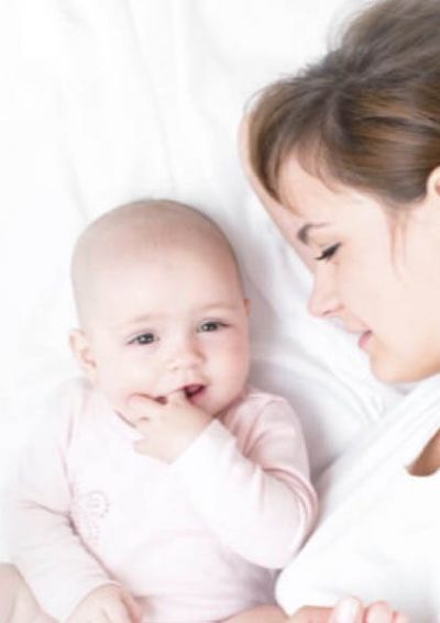 mother laying in bed next to her child