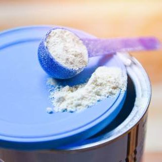 Baby formula scoop on blue lid