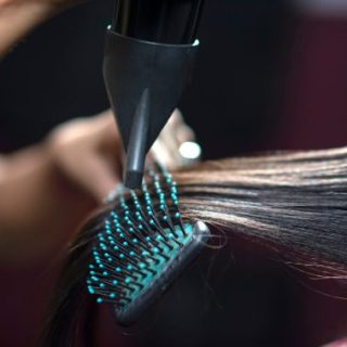 Brush and hair dryer straightening dark hair