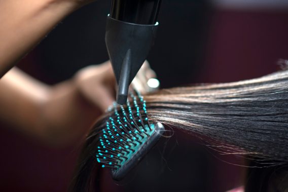 Brush and hair dryer straightening dark hair