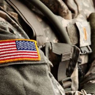 Soldier's shoulder in camouflage with flag