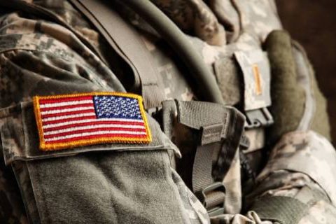 Soldier's shoulder in camouflage with flag