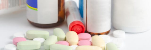 Pills and pill bottles on table