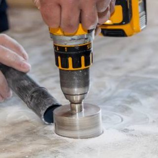 Man using circular drill to cut countertop