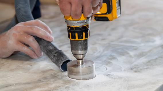 Man using circular drill to cut countertop