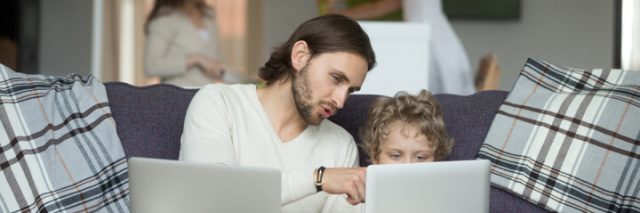 dad explaining what is on his son's laptop