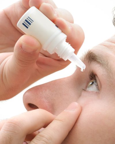 Man using eye drops