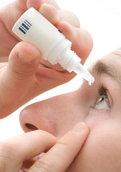 Man using eye drops