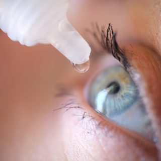 Eye drops going into woman's eye