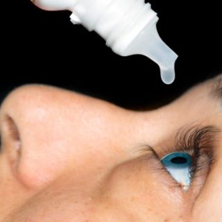 Woman using eye drops