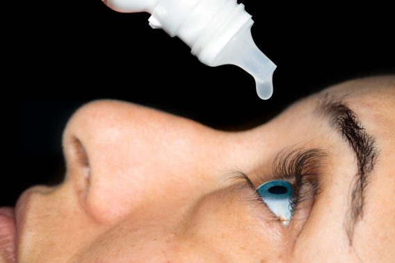 Woman using eye drops