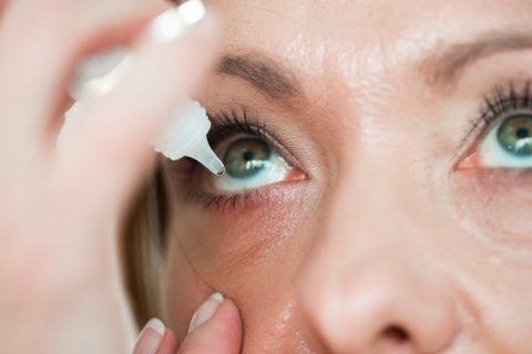Eye drops going into woman's eye
