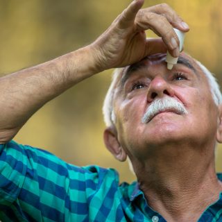 Man inserting eye drops