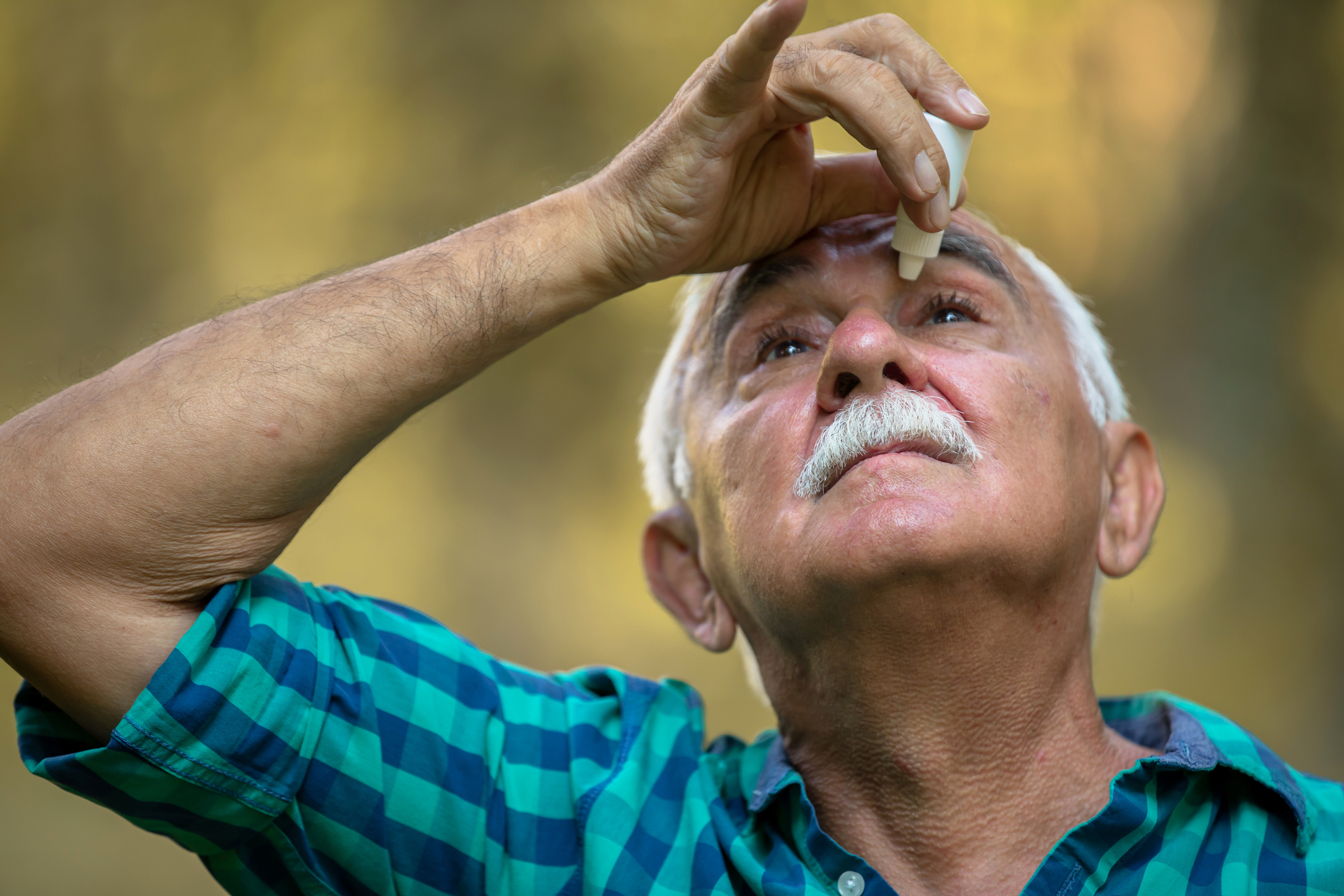 Man inserting eye drops