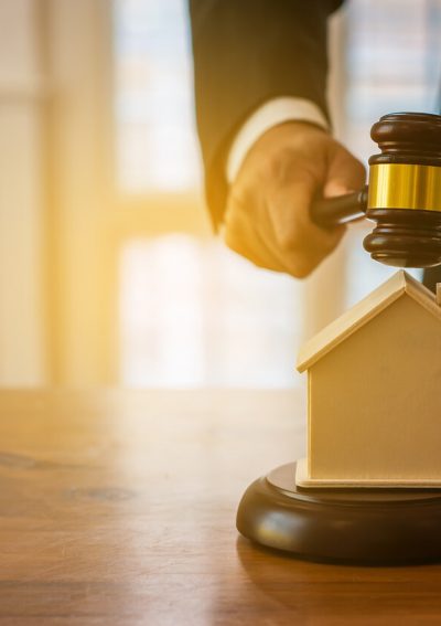judge placing gavel over wooden house
