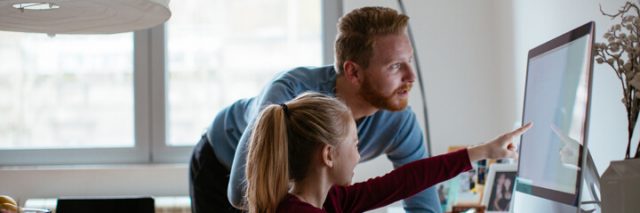 Daughter pointing to info on her computer screen