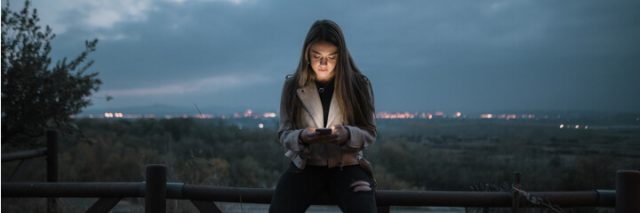girl texting at night alone