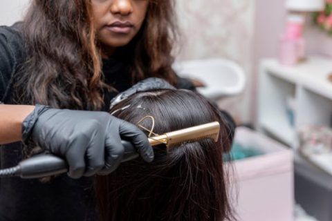 Hair stylist straightening hair