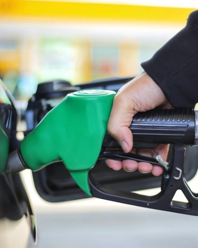 Person pumping gas into their car.