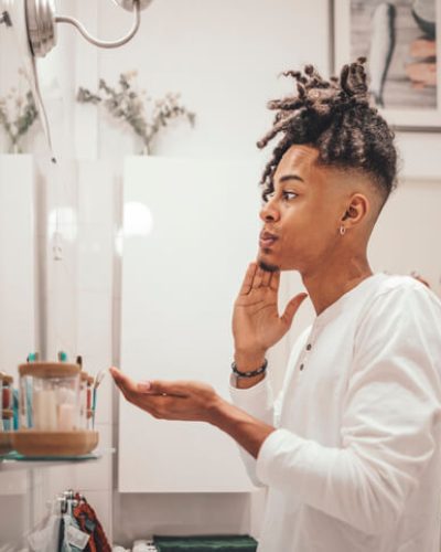 Man looking at his face in mirror