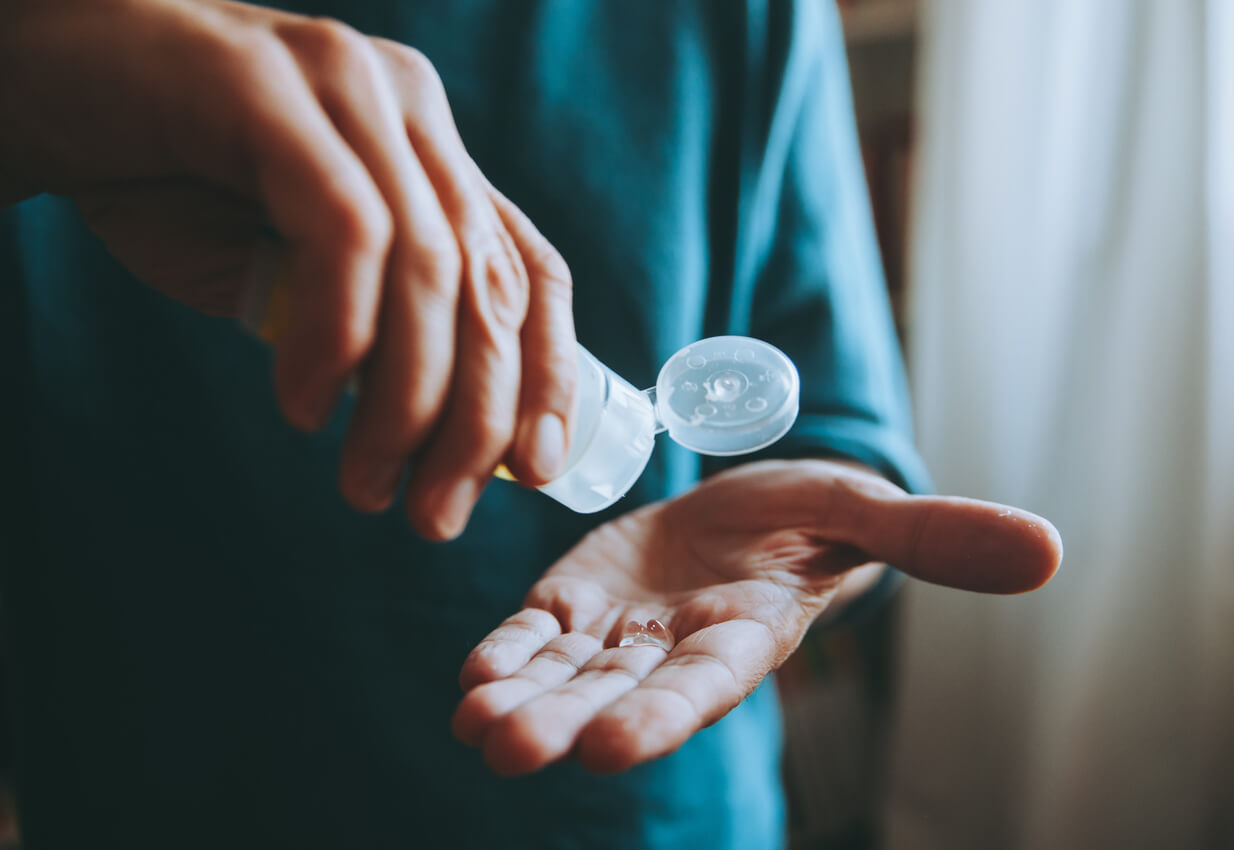 Man using hand sanitizer