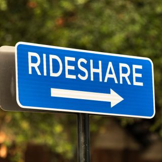 Blue rideshare road sign