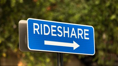 Blue rideshare road sign