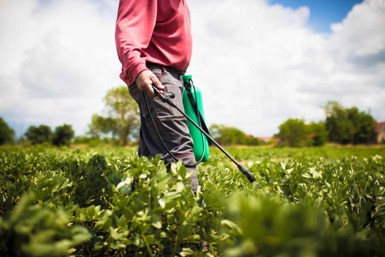 Farmer spraying crops with a pesticide