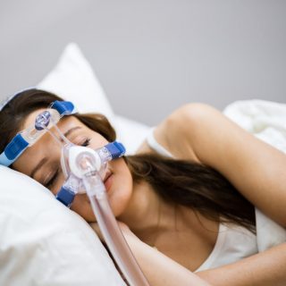 Woman sleeping with a CPAP mask on