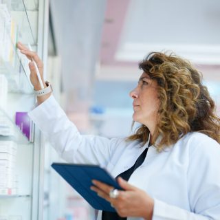 Image of a pharmacist checking a shelf.