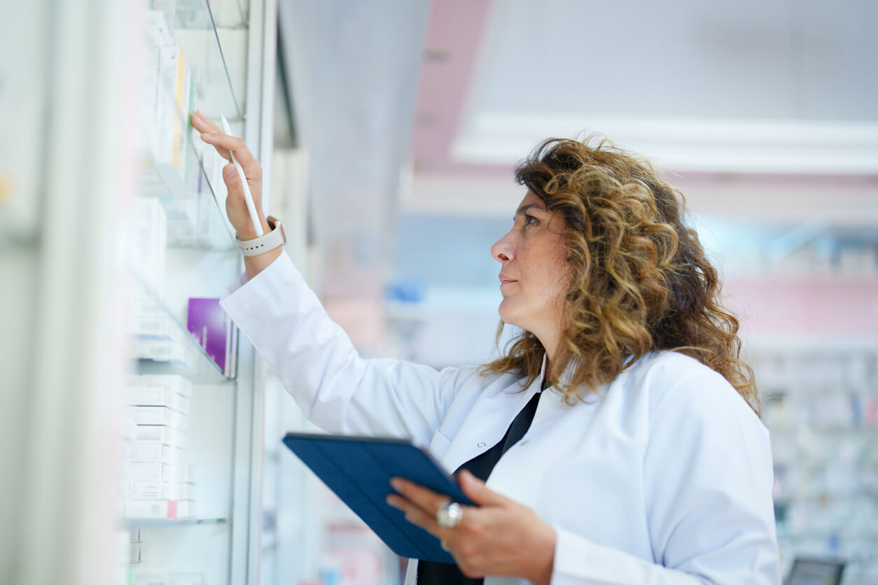 Image of a pharmacist checking a shelf.