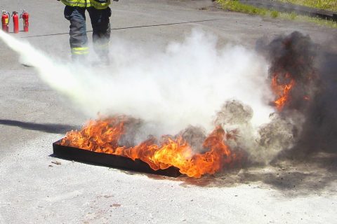 Aqueous film forming foam being sprayed over a fire