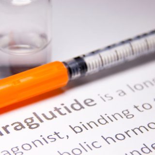A needle over text about liraglutide.