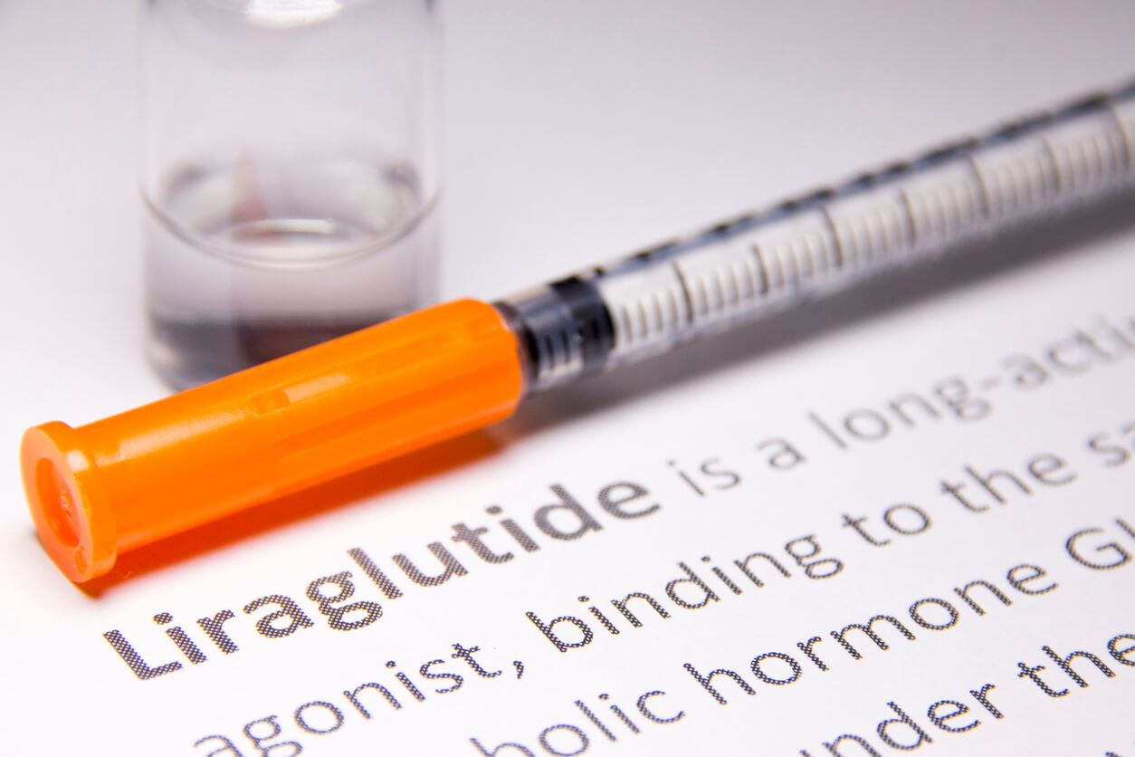 A needle over text about liraglutide.