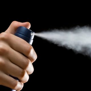 hand spraying aerosol deodorant