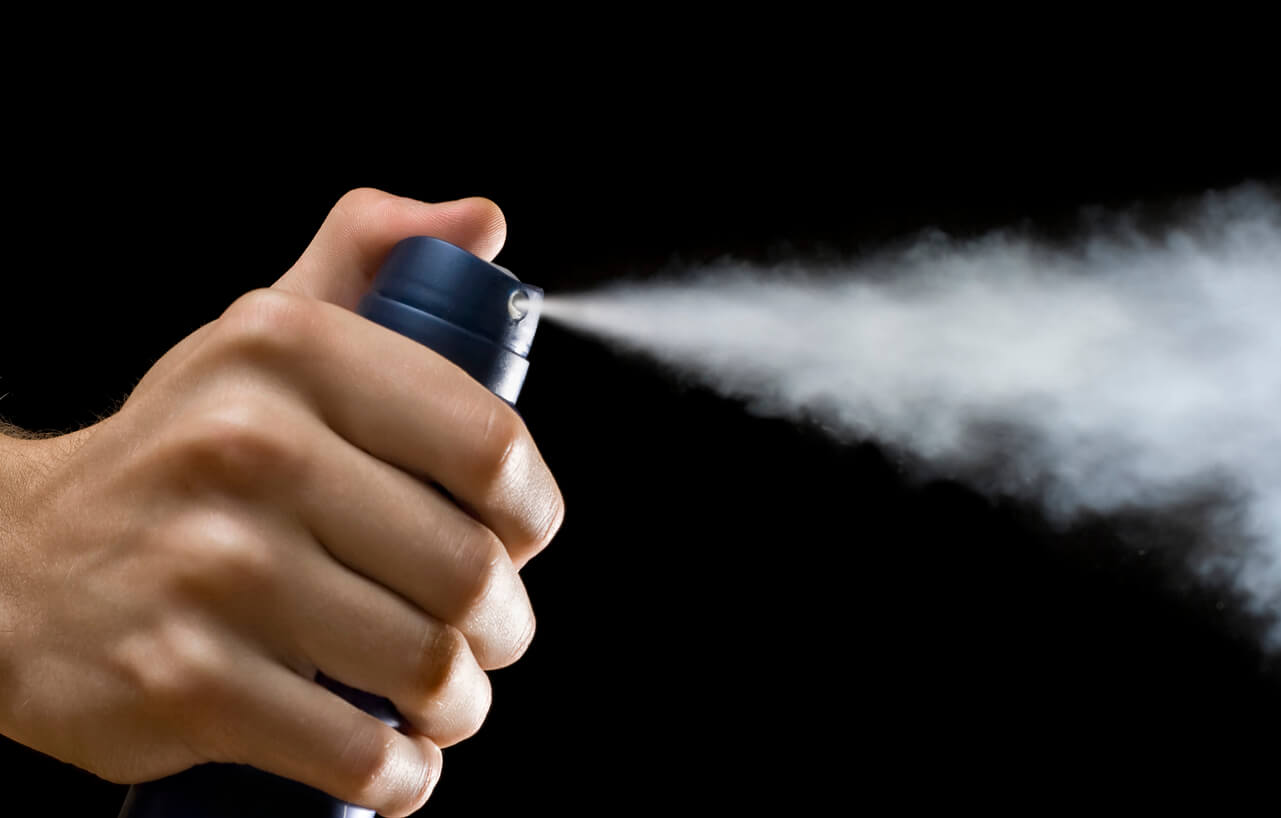 hand spraying aerosol deodorant