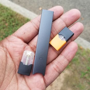 hand holding juul e-cigarette