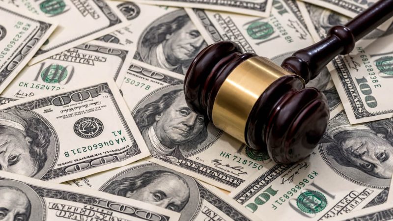 Gavel on top of pile of 100 dollar bills