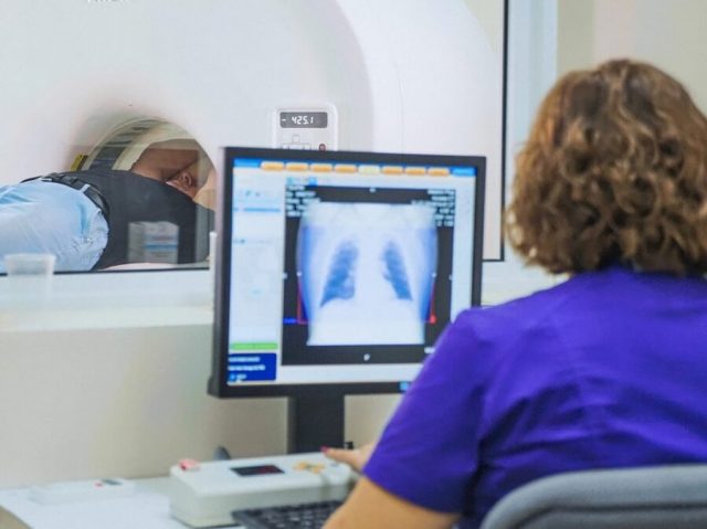 Woman analyzing MRI scan